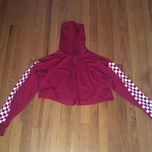 red sweater with checkered sleeves.